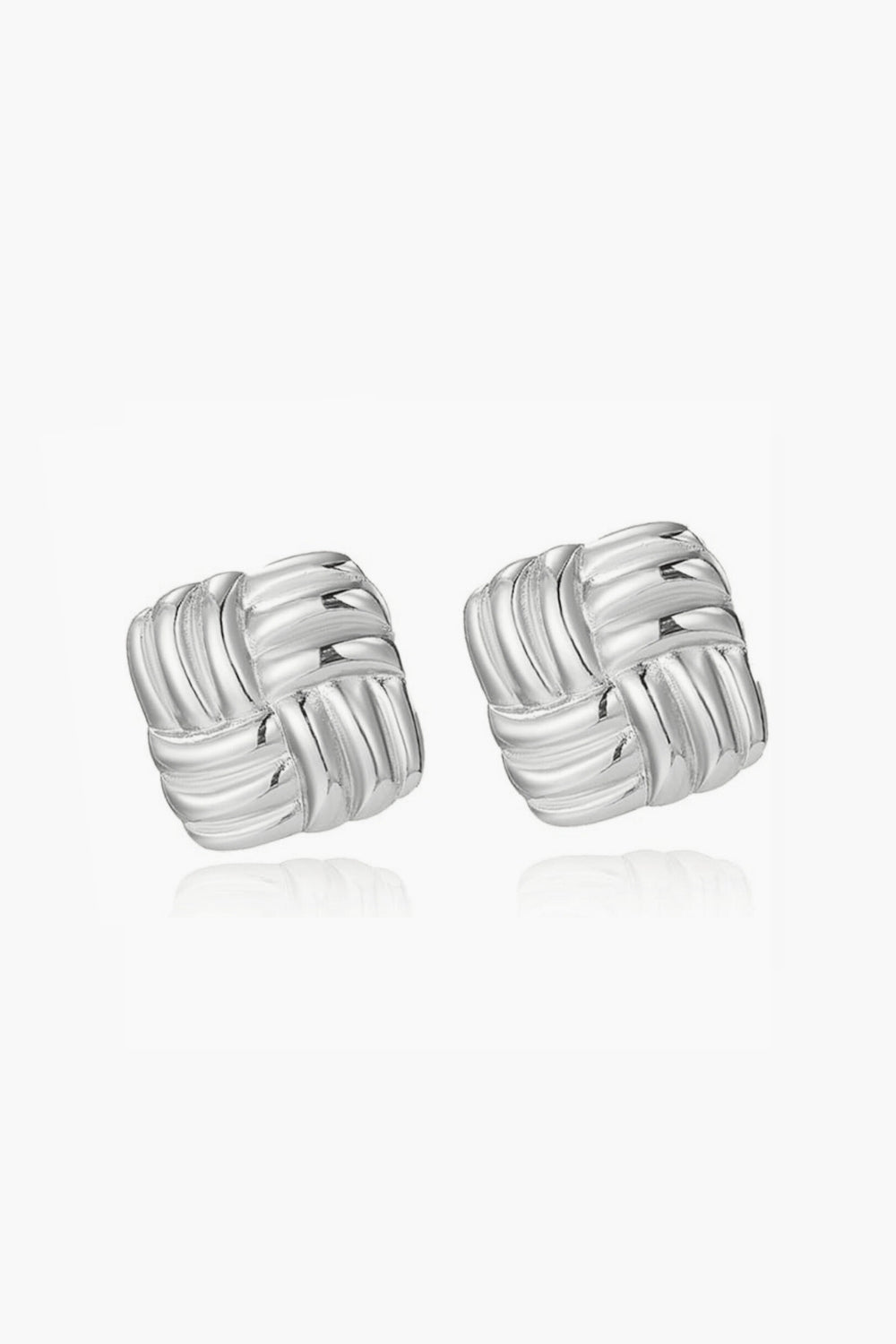 White gold woven earrings on a white background, vintage style.