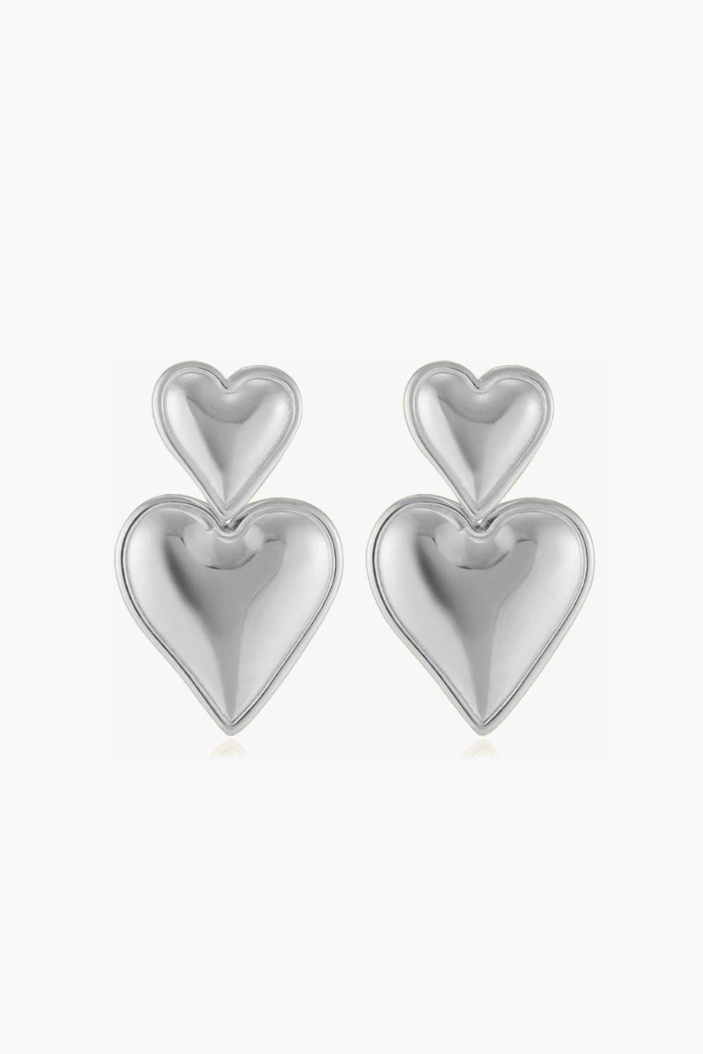 White gold double heart-shaped drop earrings on a white background