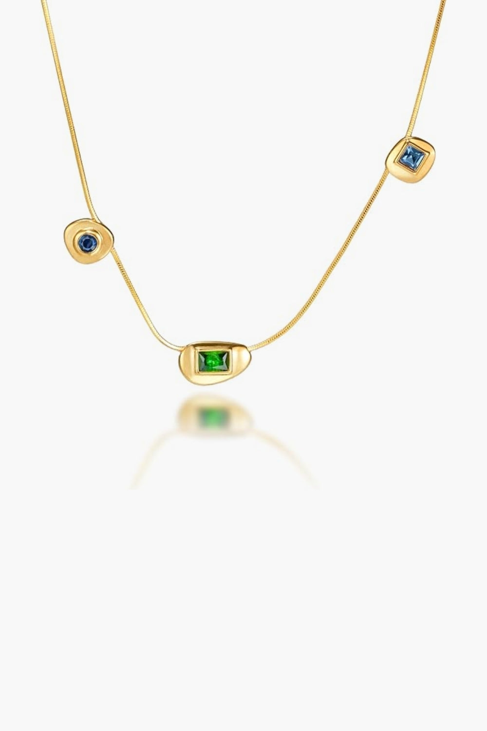 Yellow gold chain necklace with blue and green gemstones pendants on a white background.
