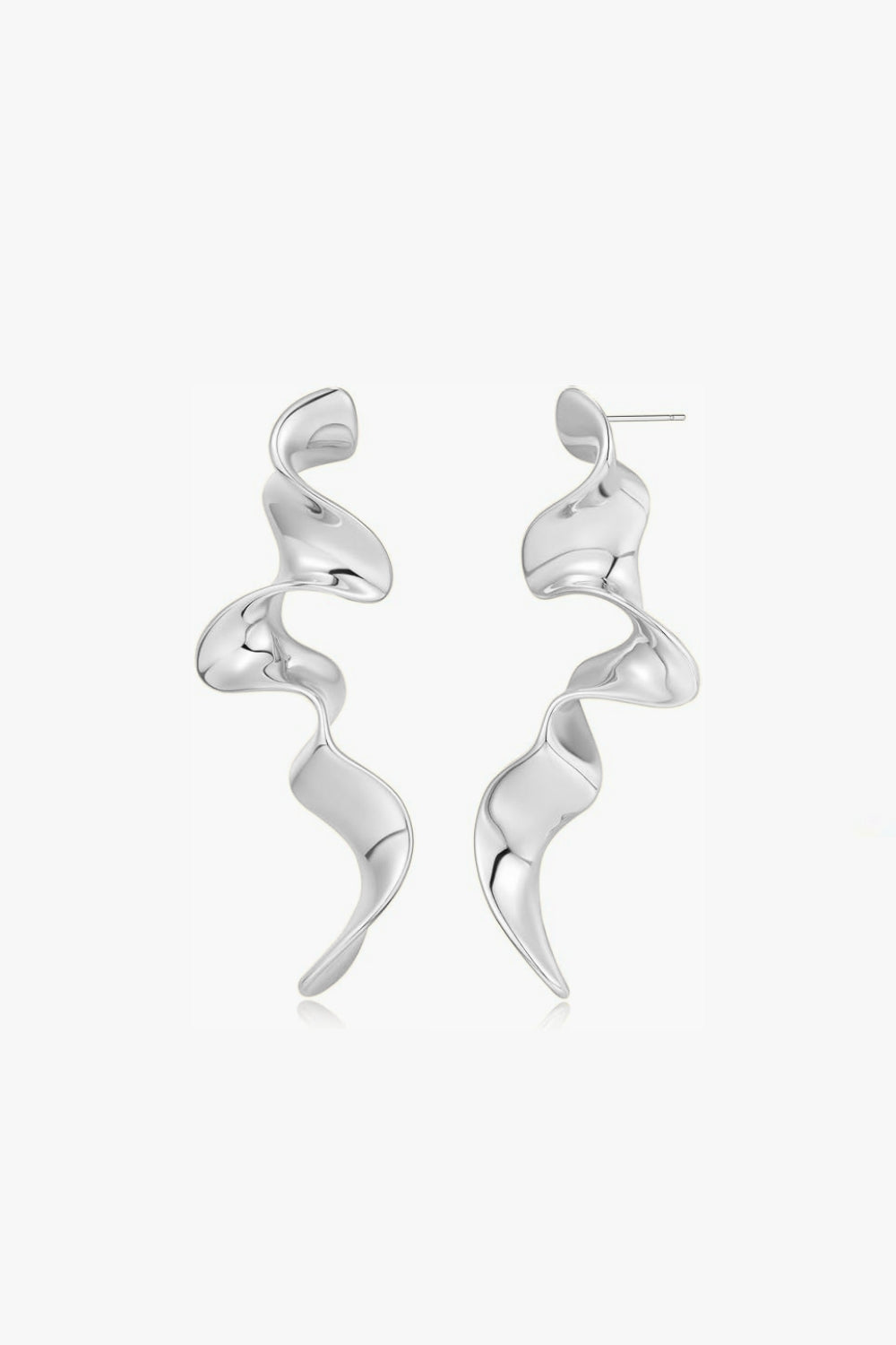 White gold spiral drop earrings on a white background, abstract design.