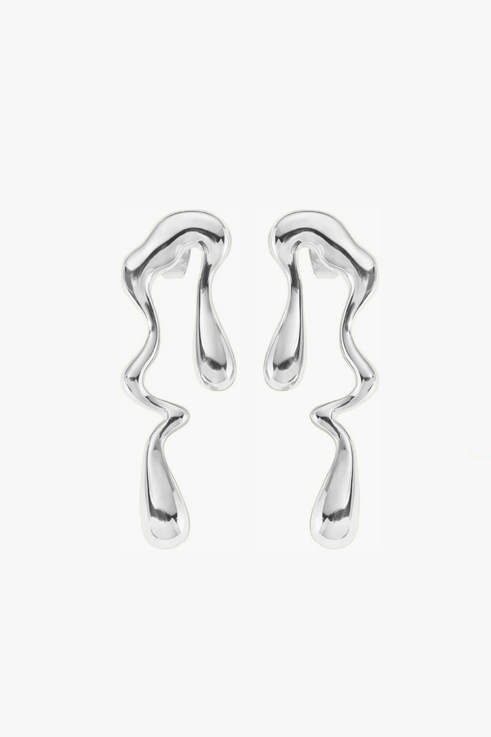 abstract, irregular shaped long drop earrings in white gold on white background.
