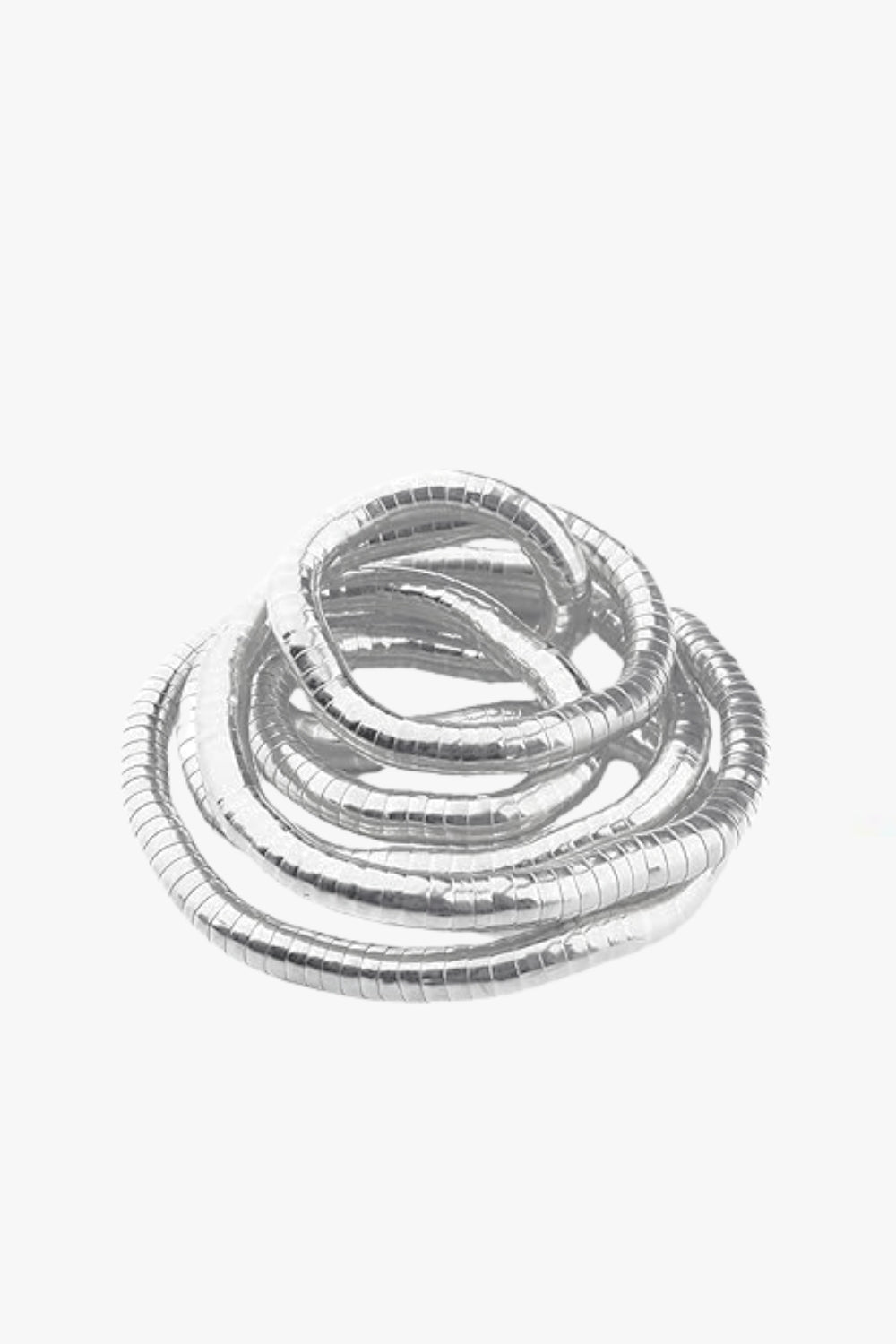 White gold spiral adjustable bracelet and necklace on a white background