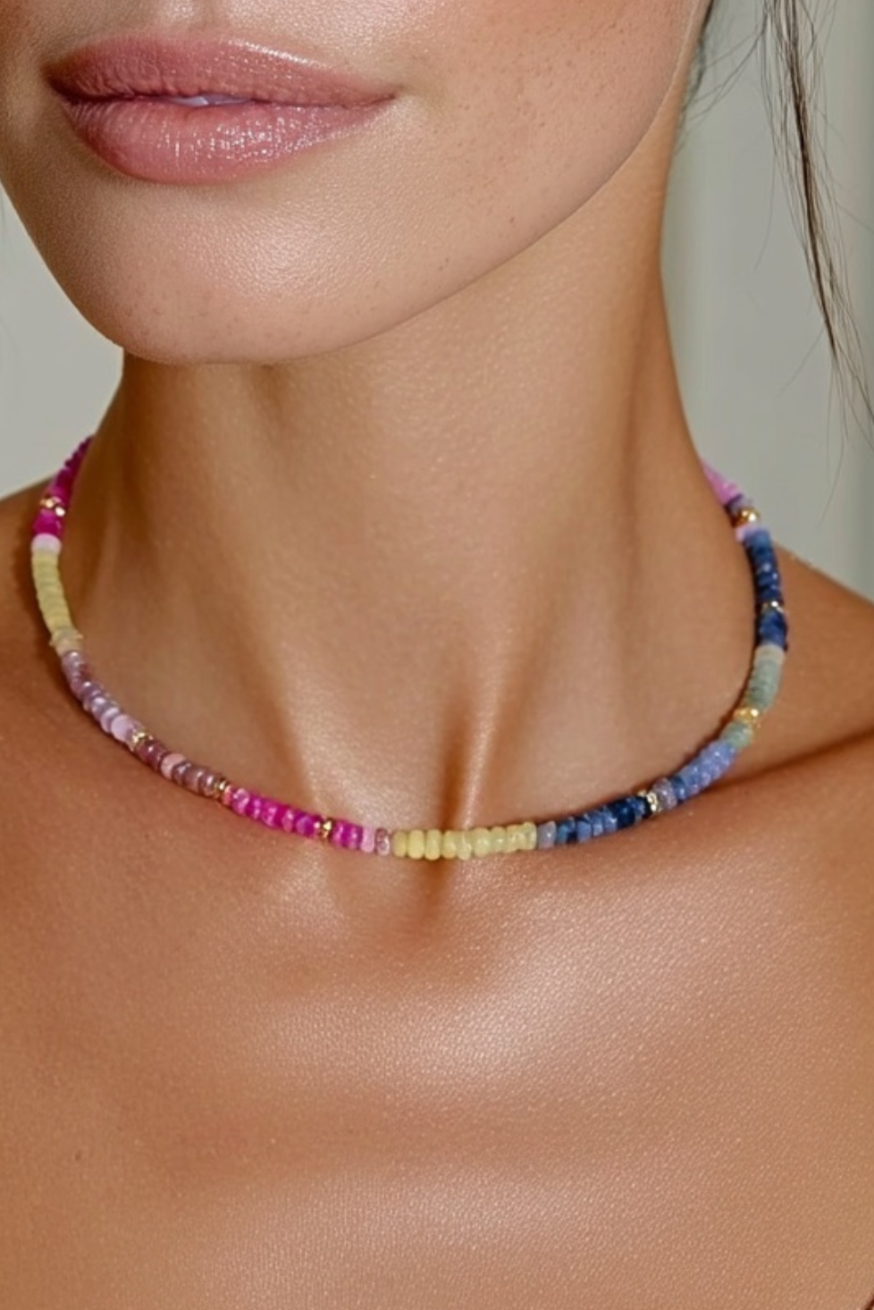 Model wearing the Lola Necklace Wildflower – slim gold-plated necklace with multi-colored gemstone beads in pink, yellow, green, and blue tones