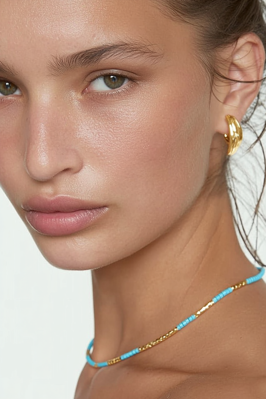 Model wearing the Lucia Necklace Riviera Dream – slim gold-plated necklace with turquoise, teal, and seafoam gemstone beads
