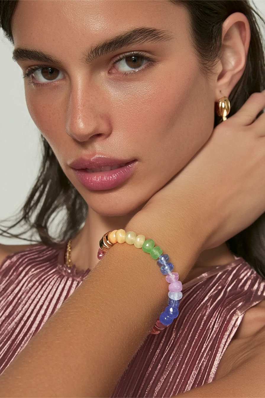 Model wearing the Marina Bracelet – 14k yellow gold-plated chunky beaded bracelet with high-gloss natural stone beads in mint green, pastel blue, and soft yellow tones.