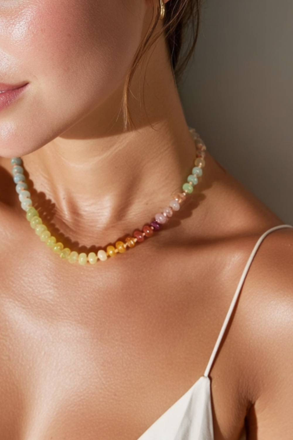 Model wearing the Marina Necklace – 14k yellow gold-plated chunky beaded necklace with high-gloss natural stone beads in ivory, blush pink, and soft gold tones.