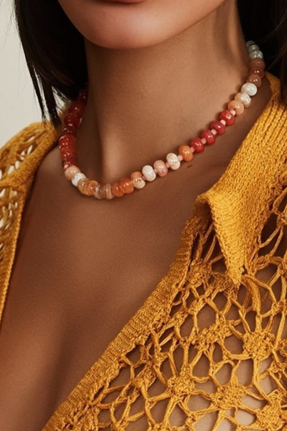 Model wearing the Marina Necklace – 14k yellow gold-plated chunky beaded necklace with high-gloss natural stone beads in orange, amber, and golden tones.