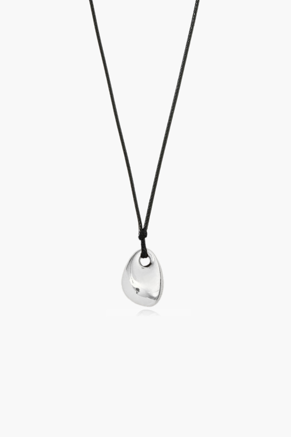 abstract shape necklace with a yellow gold pendant and black cord on a white background