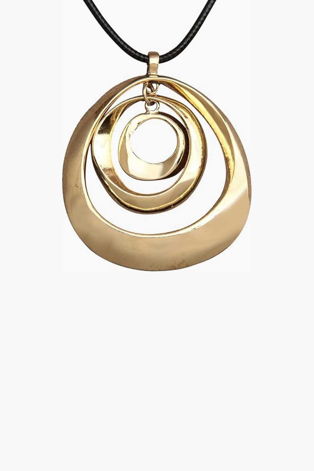 Close up of yellow gold circular three layer pendant necklace with black cord on white background.