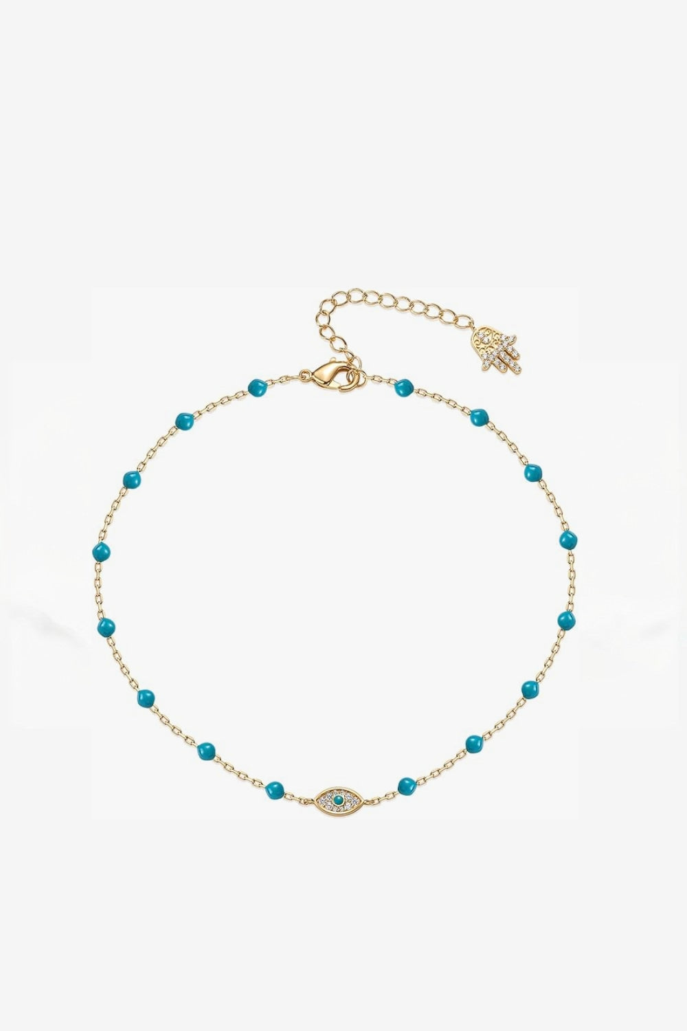 Yellow gold anklet with evil eye and turquoise beads on a white background