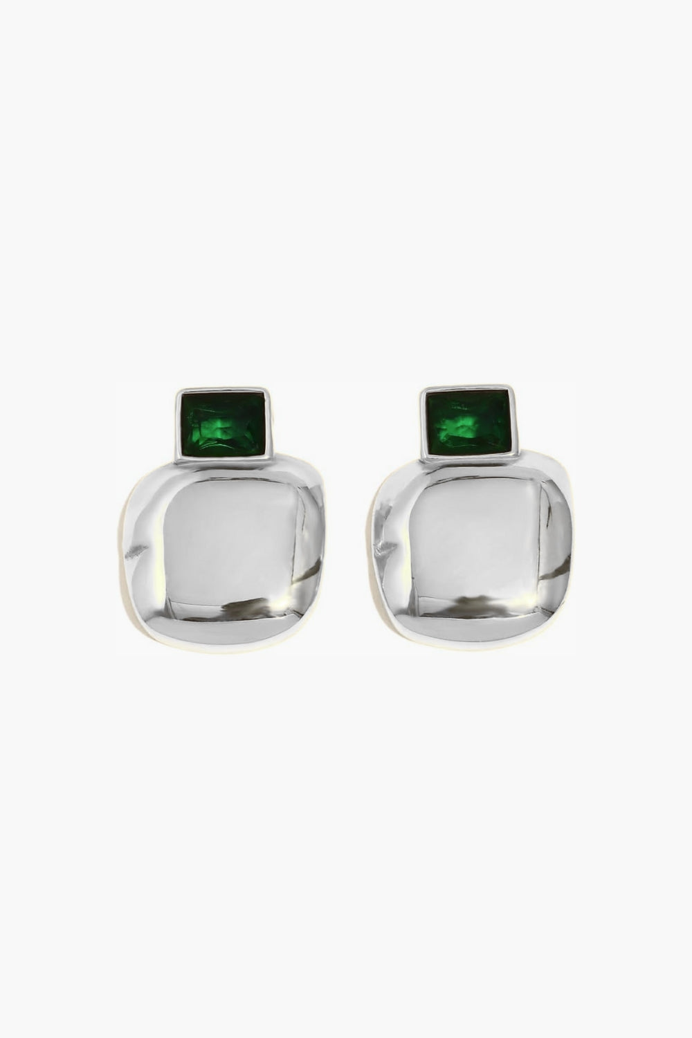 White gold earrings with emerald green gemstones on a white background.