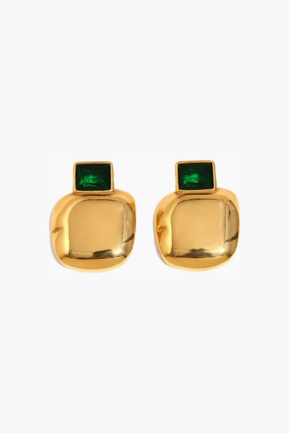 Yellow gold earrings with emerald green gemstones on a white background