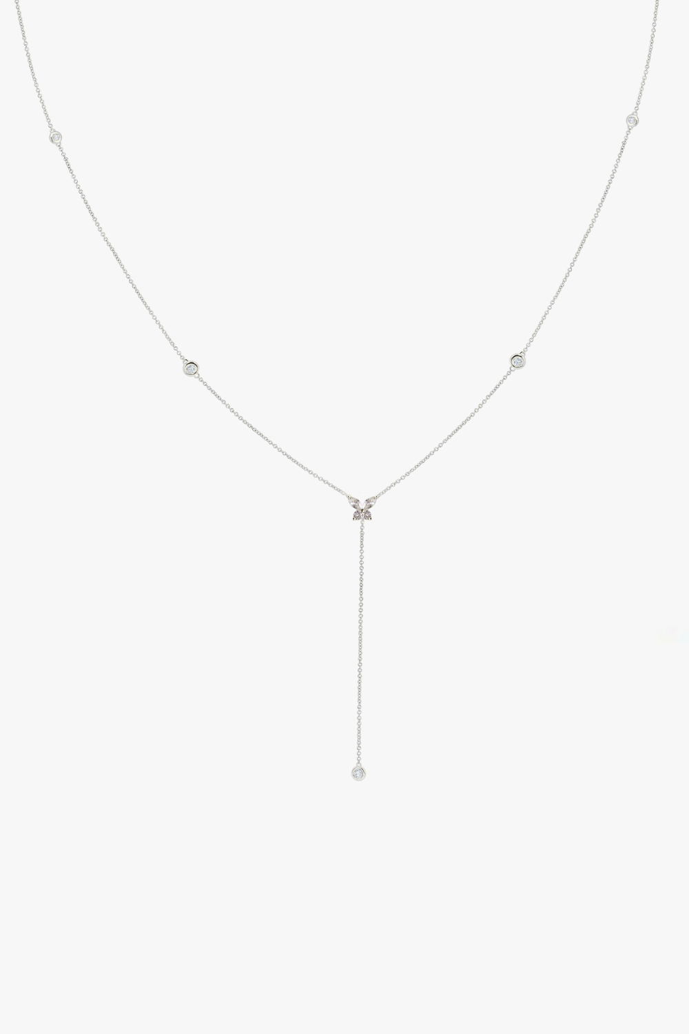 Delicate white gold butterfly lariat necklace with small bezel diamonds.