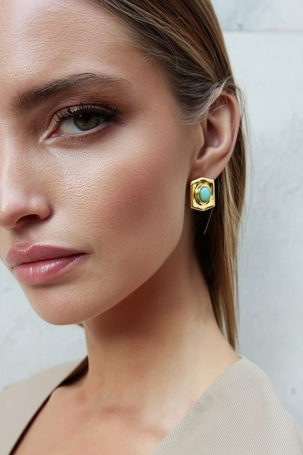 Model wearing the Astra Earrings – 14k yellow gold-plated hexagon-shaped earrings with polished turquoise cabochon center.