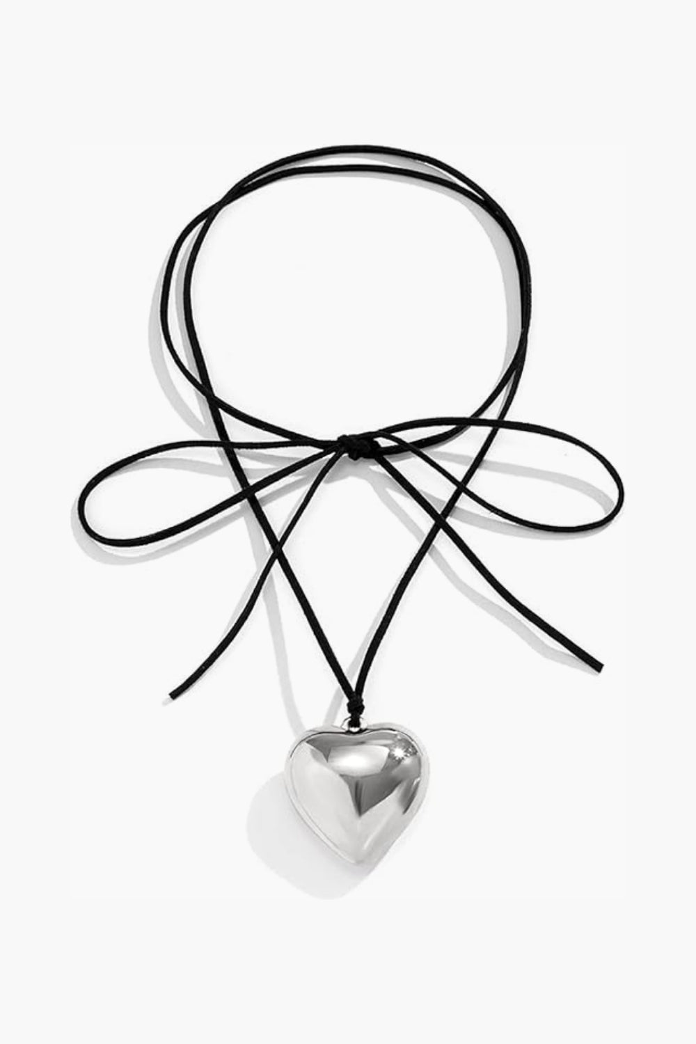 White gold heart-shaped pendant on a black cord rope against a white background.