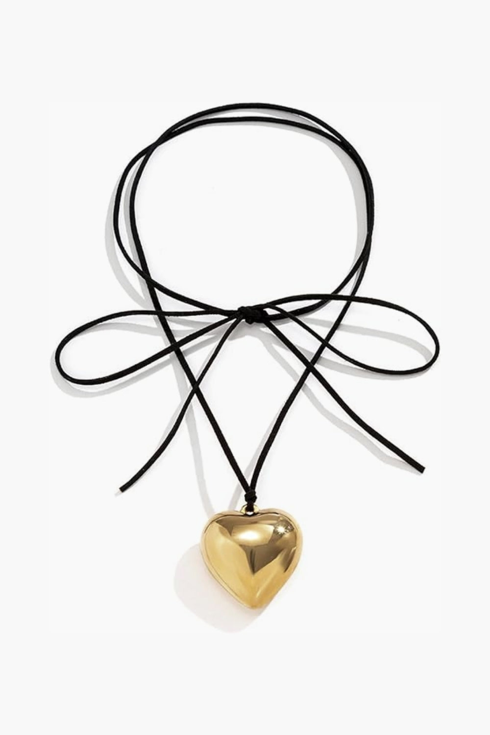 Yellow gold heart-shaped pendant on a black cord rope against a white background.