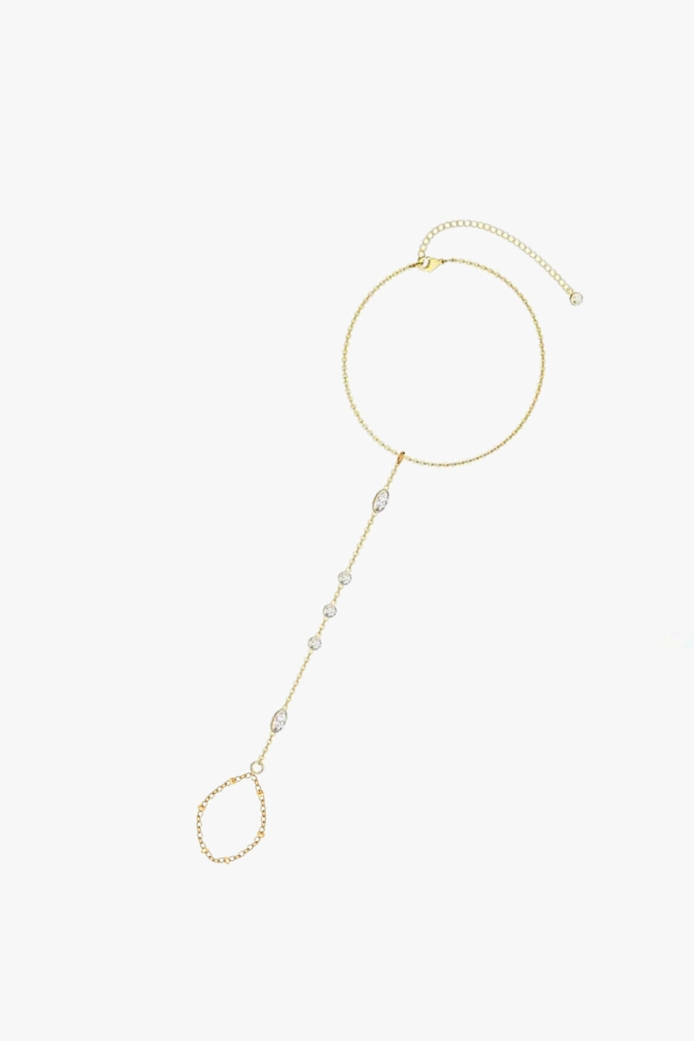 Clara yellow gold hand chain bracelet with bezel-set stones, finger loop, and delicate adjustable chain.