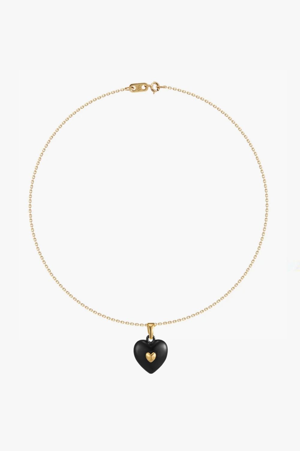 Necklace with a black heart-shaped pendant and yellow gold details on white background.