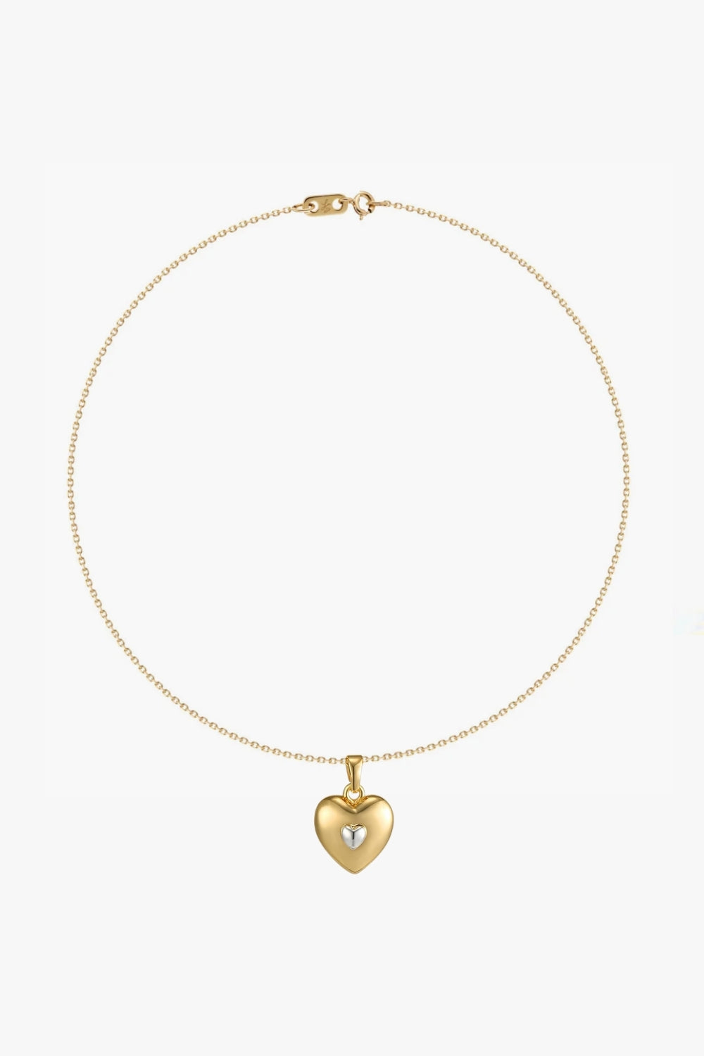 yellow gold necklace with heart-shaped pendant and white gold details on white background.