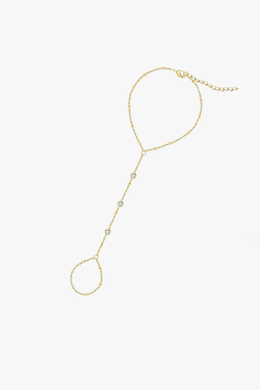 Gaby hand chain bracelet in yellow gold with three bezel-set stones, finger loop, and delicate adjustable chain.