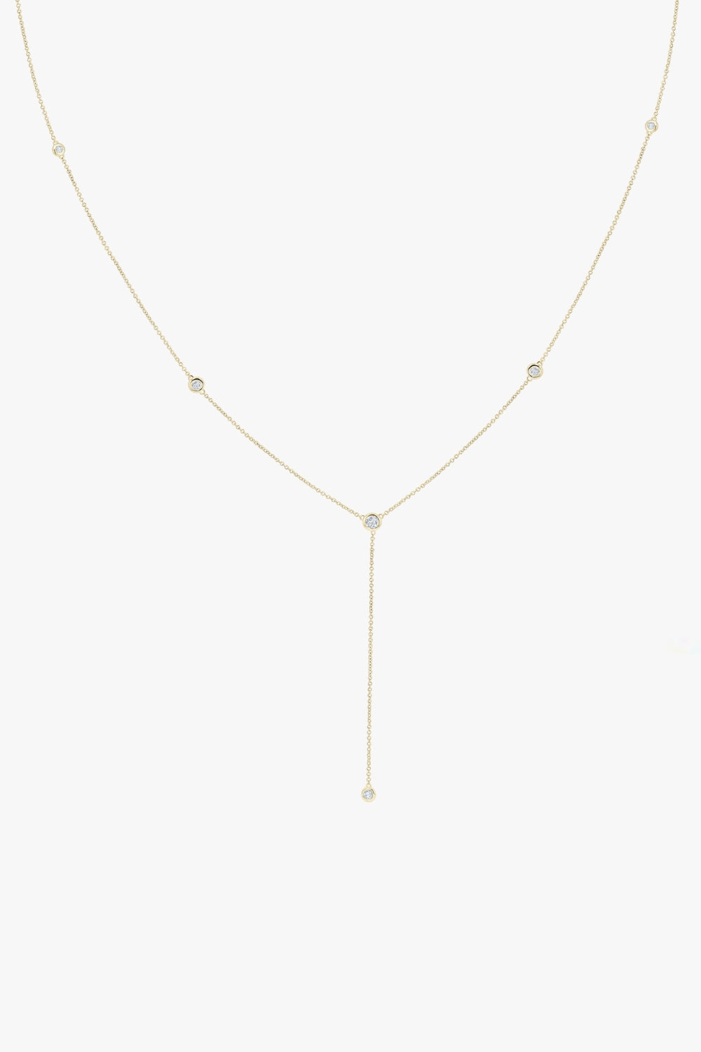 Gaby yellow gold y-shaped necklace with five bezel set stones and lariat drop.