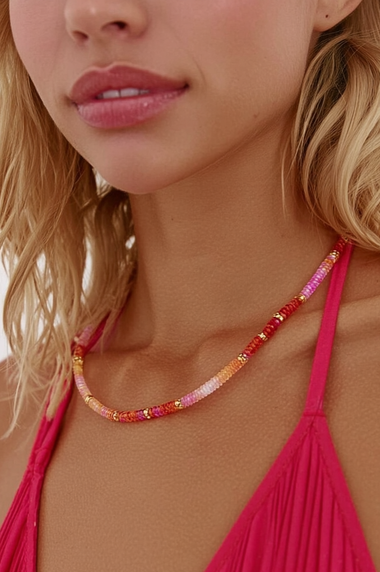 Model wearing the Lola Necklace Poppy – slim gold-plated necklace with red, blush, and coral gemstone beads
