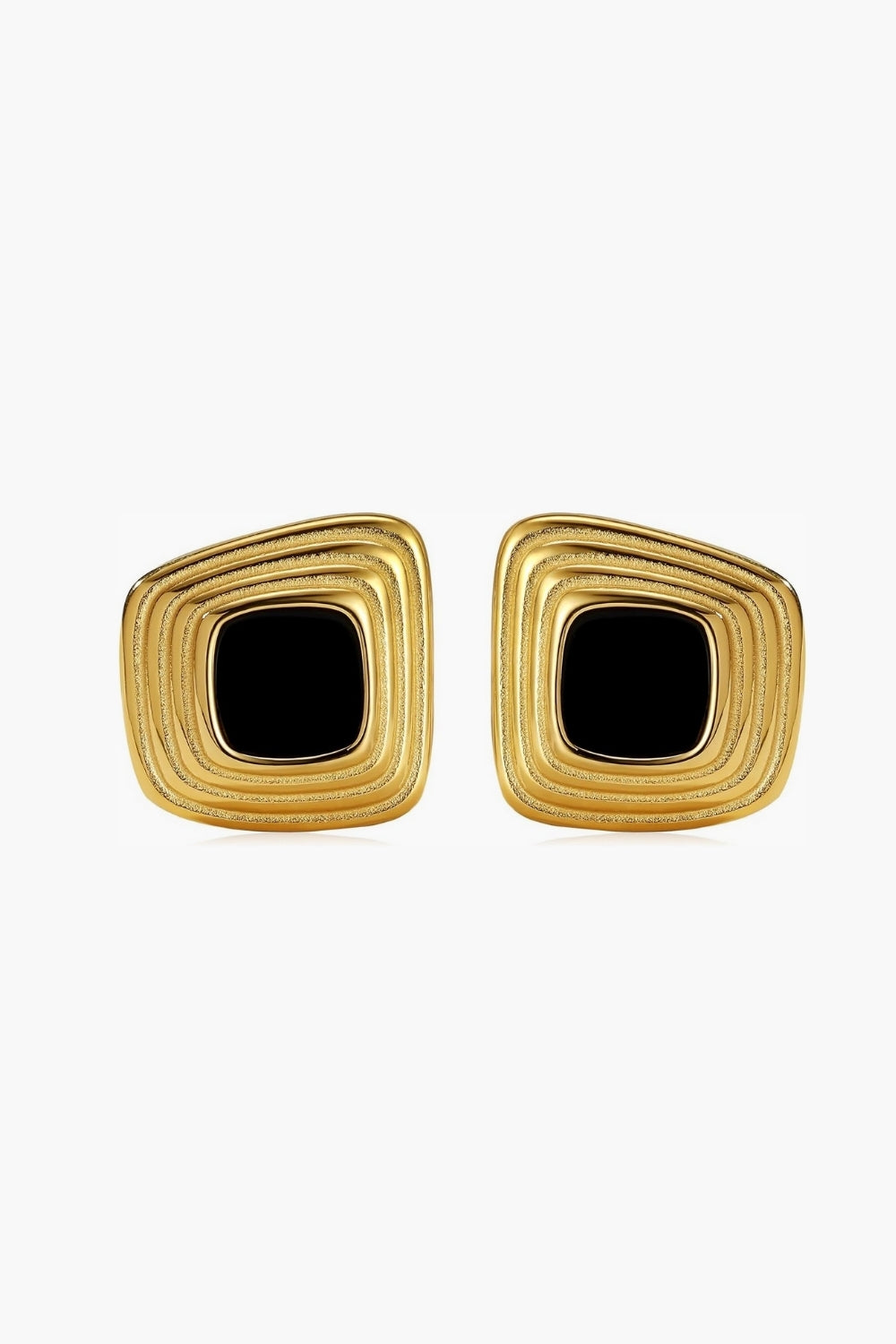 Chunky yellow gold framed earrings with black center on a white background, vintage feel.