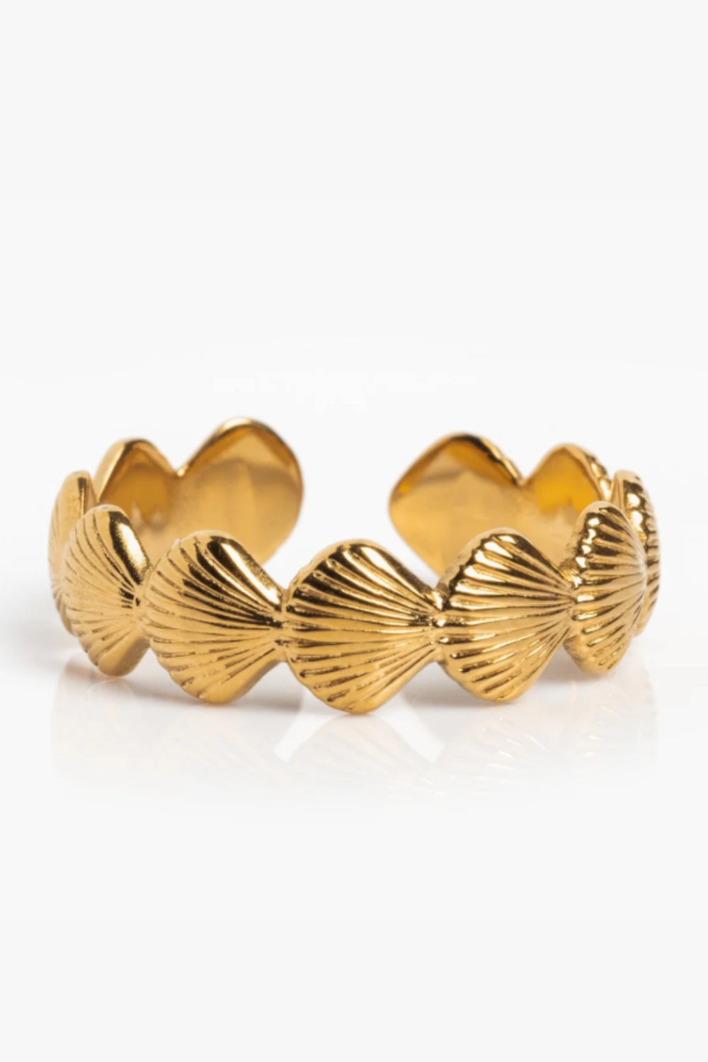 Noemi Cuff – 14k gold-plated open cuff bracelet with sculpted scallop shells and slight flexibility, on white background.