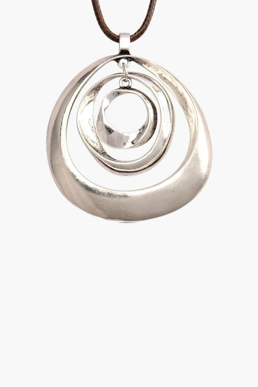 Close up of white gold three layer pendant necklace and brown cord on a white background.