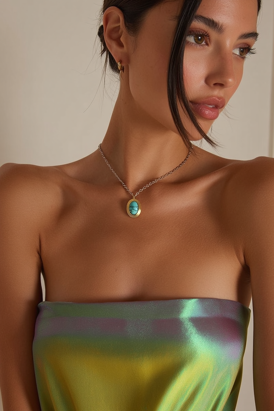 Model wearing the Rumi Necklace – 18k yellow gold-plated delicate chain necklace with natural turquoise oval pendant in glossy gold frame.