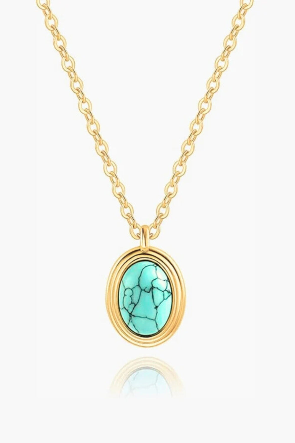 Rumi Necklace – 18k yellow gold-plated delicate chain necklace with natural turquoise oval pendant in glossy gold frame, on white background.