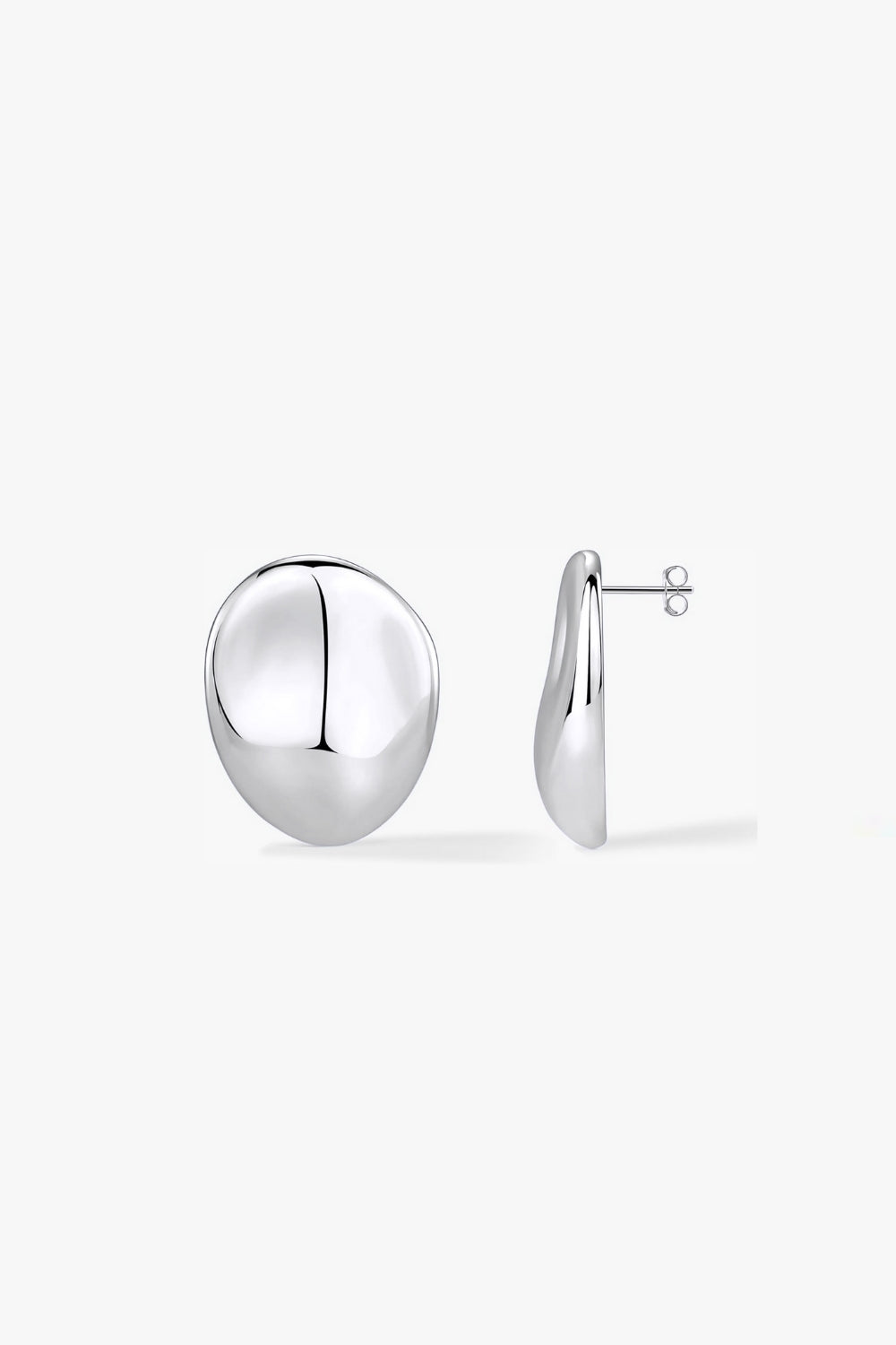 Pair of textured, abstract round earrings in white gold on a white background.