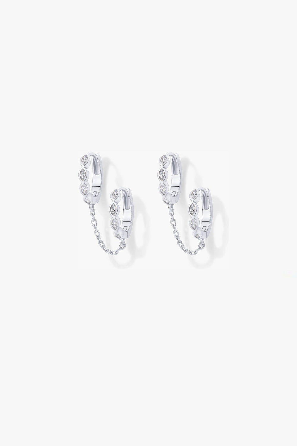 Selena white gold marquise huggie earrings linked by chain.