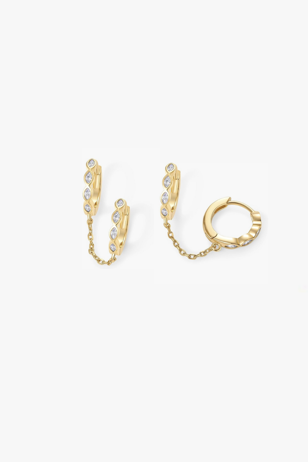 Selena yellow gold marquise huggie earrings linked by chain.
