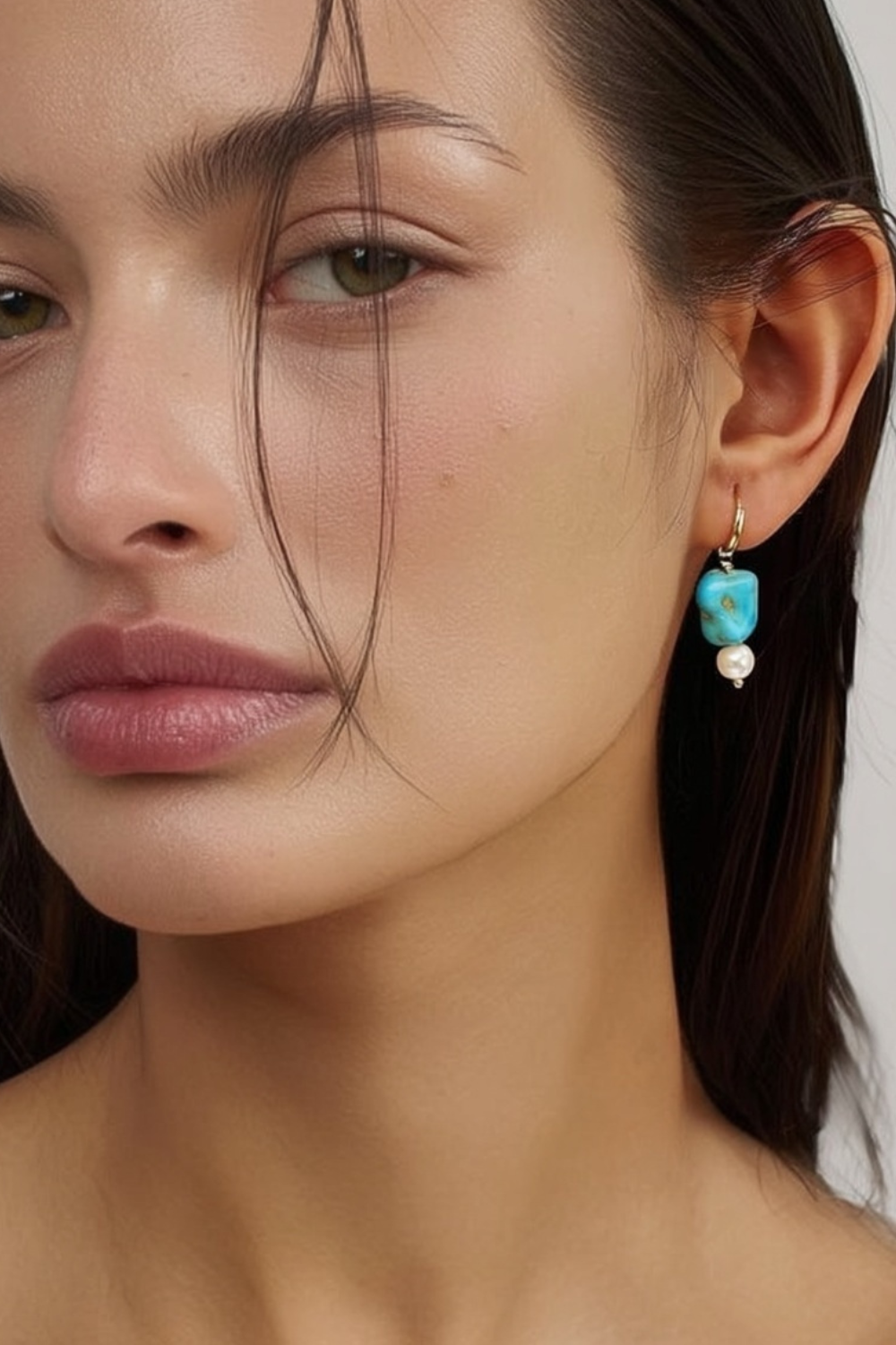 Model wearing the Sofi Earrings – 14k yellow gold-plated hoop earrings with turquoise bead and white pearl accent.
