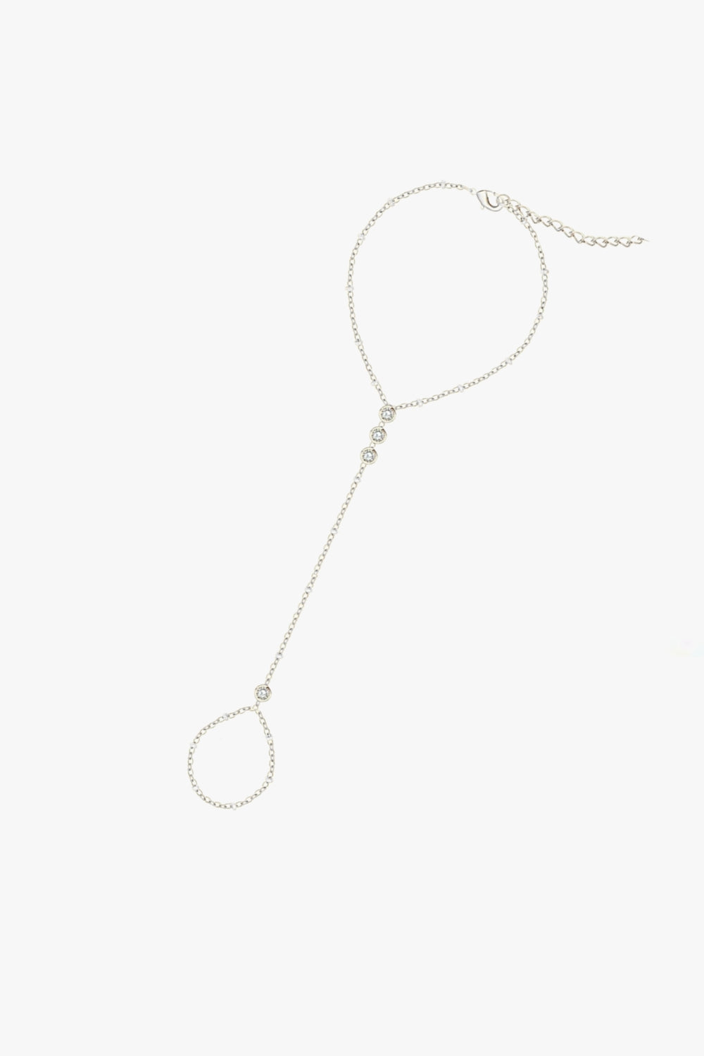 Tali hand chain bracelet in white gold, featuring bezel-set stones, delicate finger loop, and adjustable clasp.