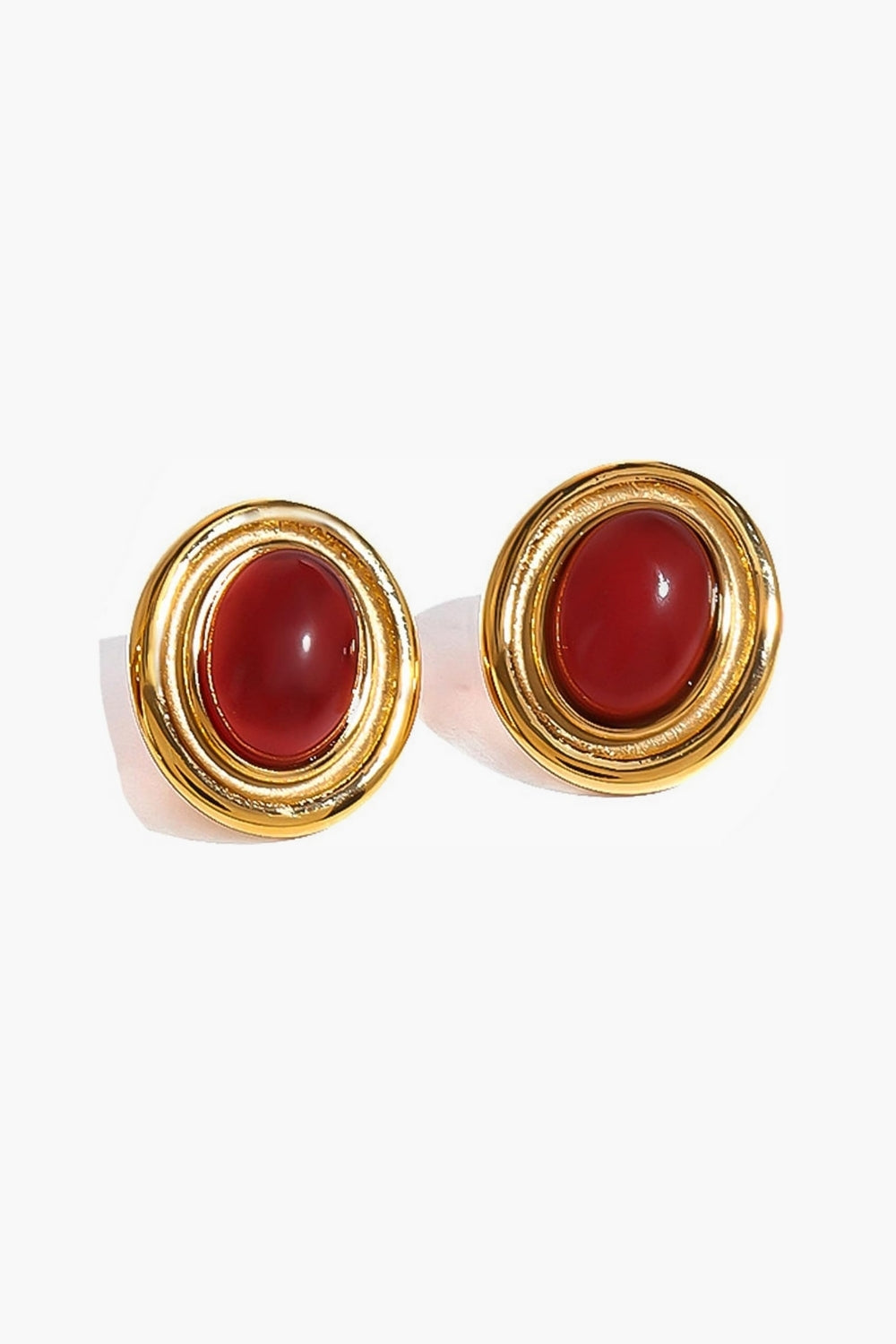 Yellow gold chunky oval earrings with red stones vintage feel on a white background
